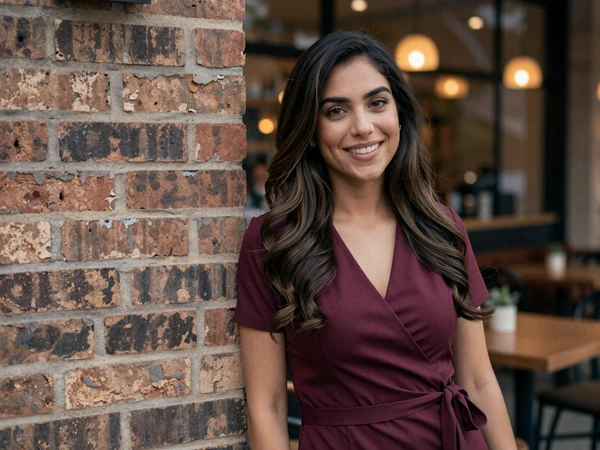 Female emergency physician smiling outside an upscale cafe in the evening